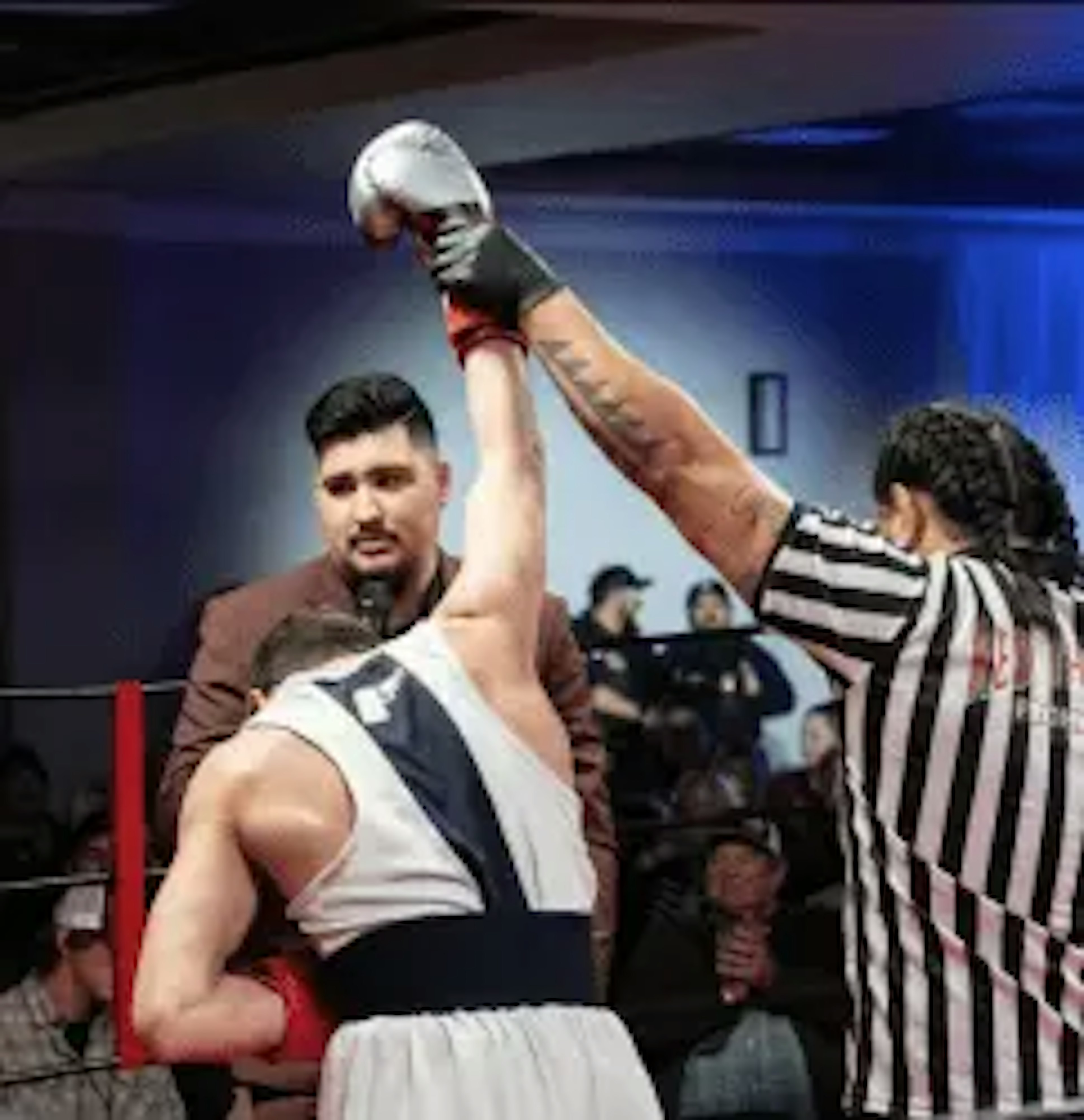 A boxer having his hand raised after a win.